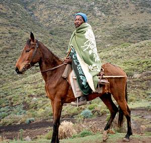 Man riding a Basotho pony in the mountains. 